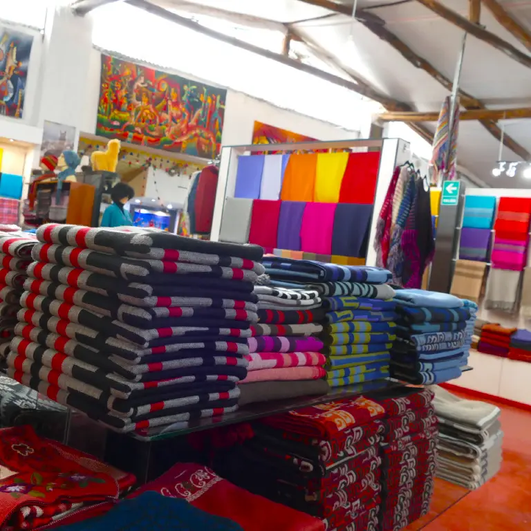 Alpaca textiles and blankets displayed in artisan store in Cusco Peru