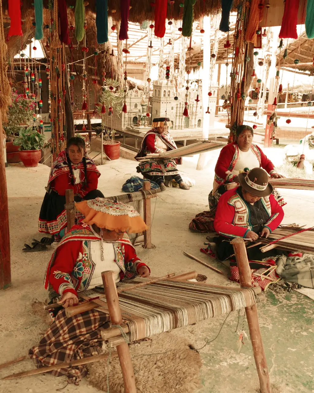 Andean women weaving traditional alpaca textiles in Cusco